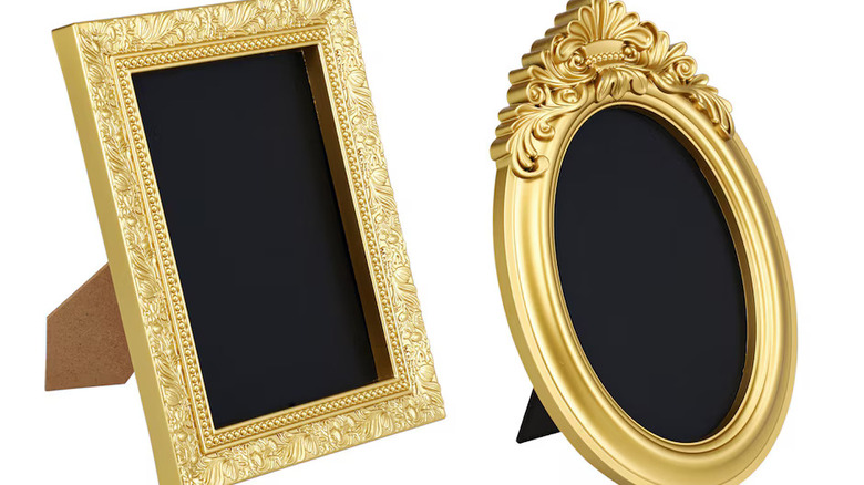 A square framed chalkboard and an oval framed chalkboard, both with ornate gold frames
