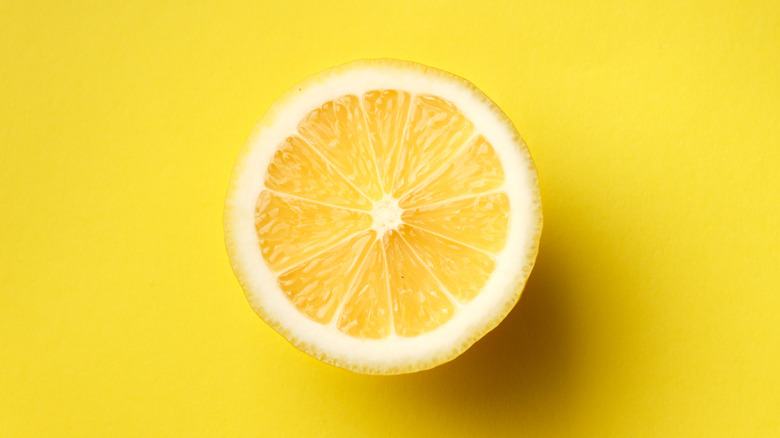 Half a lemon on a yellow background