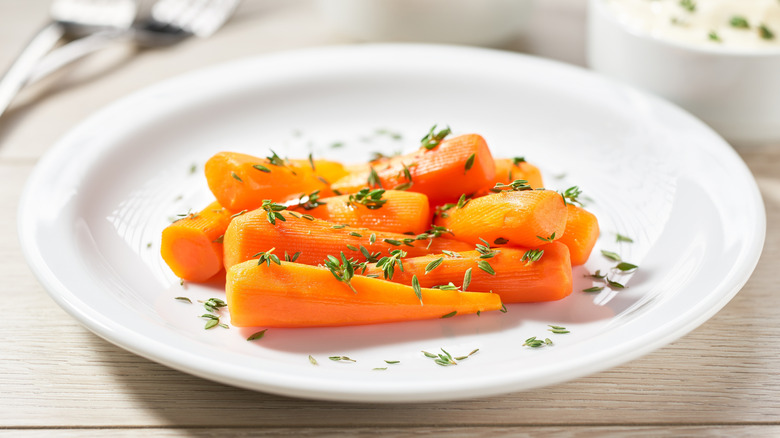 Plate of roasted carrots with a honey glaze and fresh herbs
