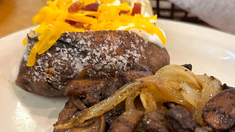 Close-up of Texas Roadhouse steak with grilled onions and mushrooms