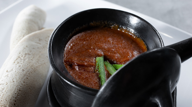 Bowl of shiro and chiles with injera