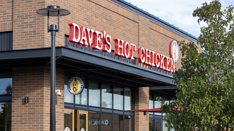 The exterior of the restuarant with a large sign over the door