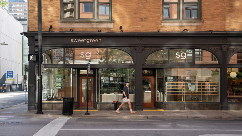 The exterior of Sweetgreen with a man walking past