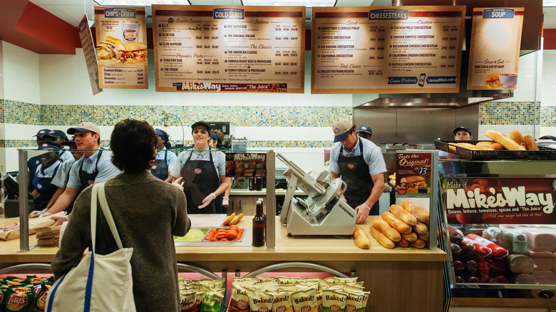 Staff preparing sandwiches behind the counter at Jersey Mike's