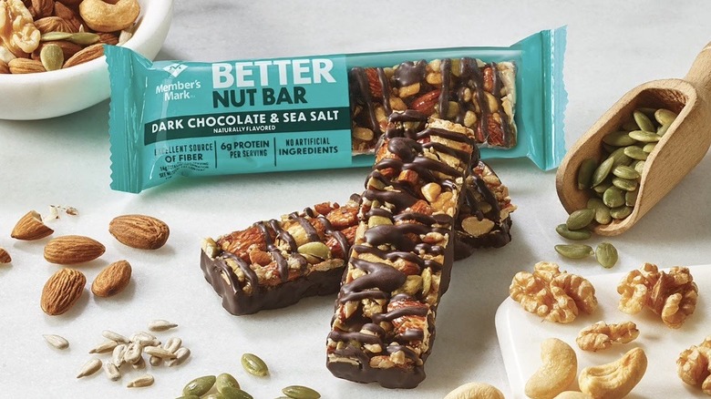 Member's Mark Better Nut Bars surrounded by ingredients of seeds and nuts