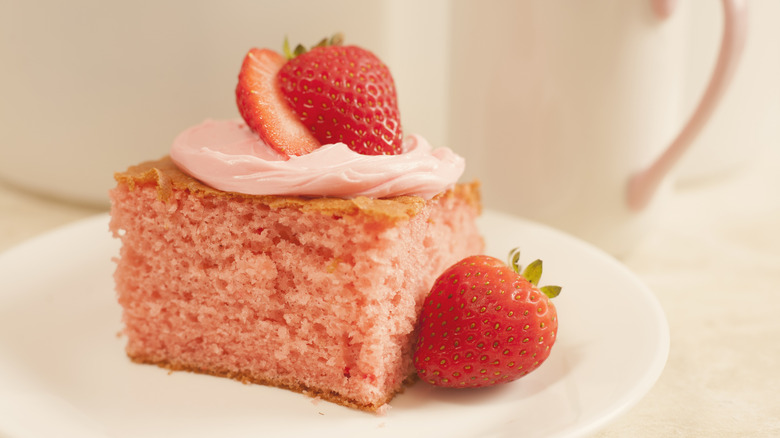 Slice of pink Champagne cake with fresh strawberries