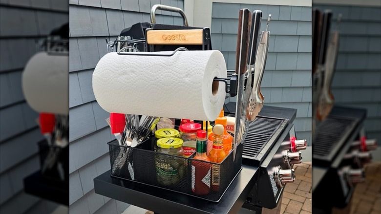 Caddy sitting on a side table of a gas grill.