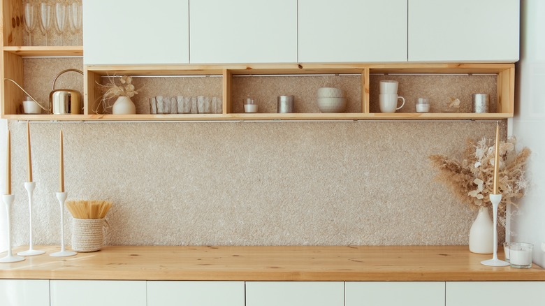 Open shelves installed between countertop and cabinets