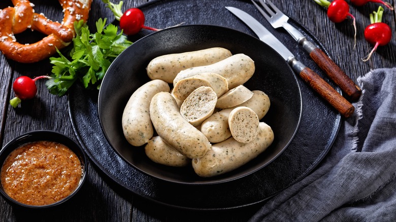 Bowl of weisswurst with mustard and pretzel