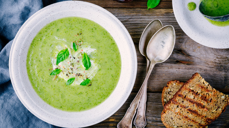 Green vegetable soup topped with fresh basil.