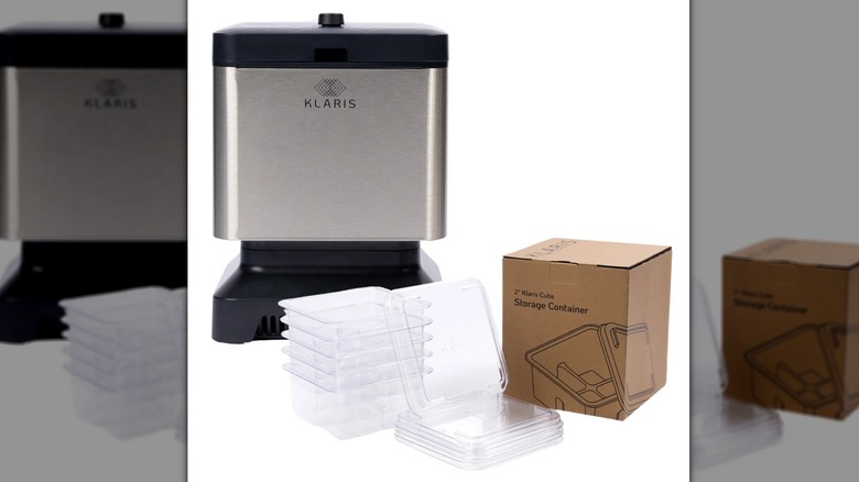 A stainless steel ice maker with a black plastic base