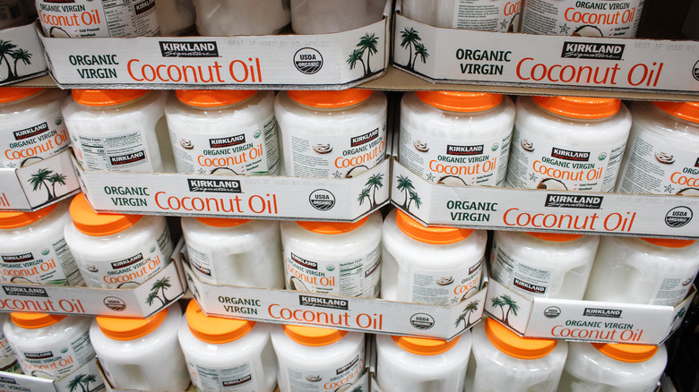 Jars of Kirkland Signature Organic Virgin Coconut Oil stacked in cases