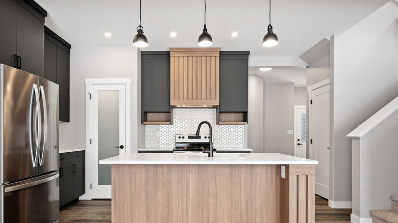 Modern kitchen with black statement pendant lights over the island