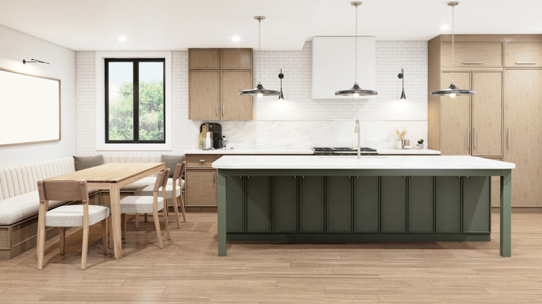 Green kitchen island in a light and breezy kitchen