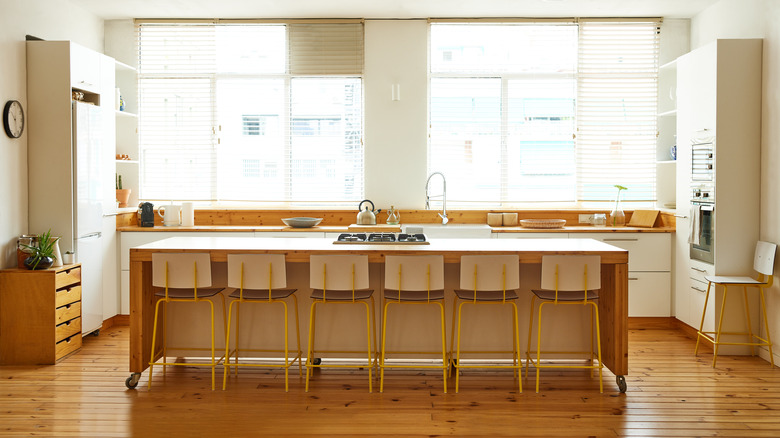 Bright white and hickory kitchen with large wooden island and ample seating