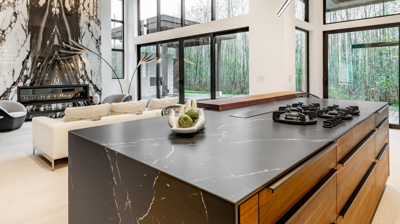Kitchen island with black granite countertop and wood drawers
