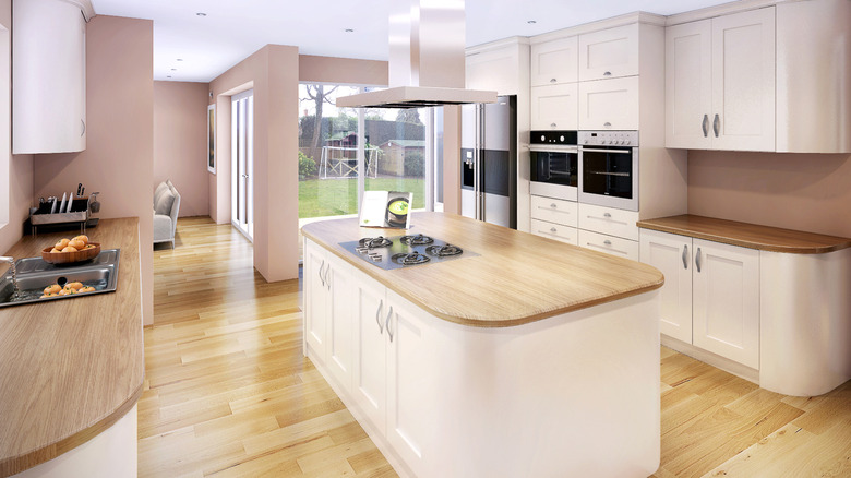 Kitchen that features a rounded island with curved countertops