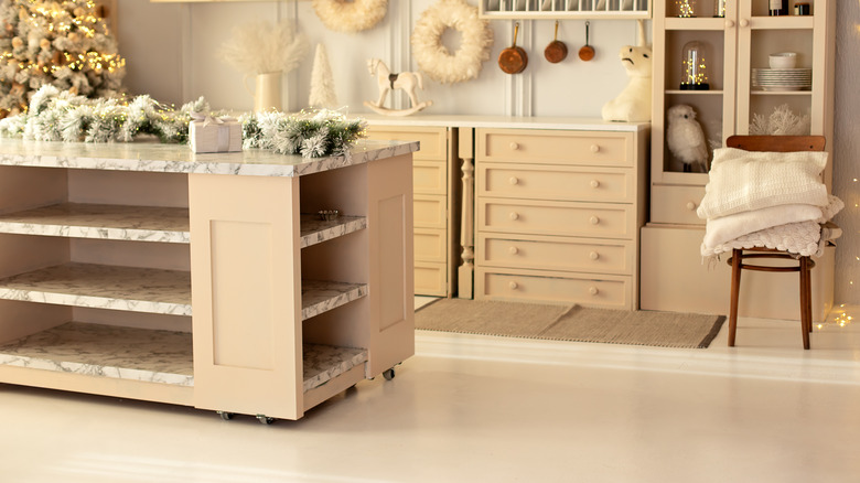 Kitchen island with open shelving decorated for holidays
