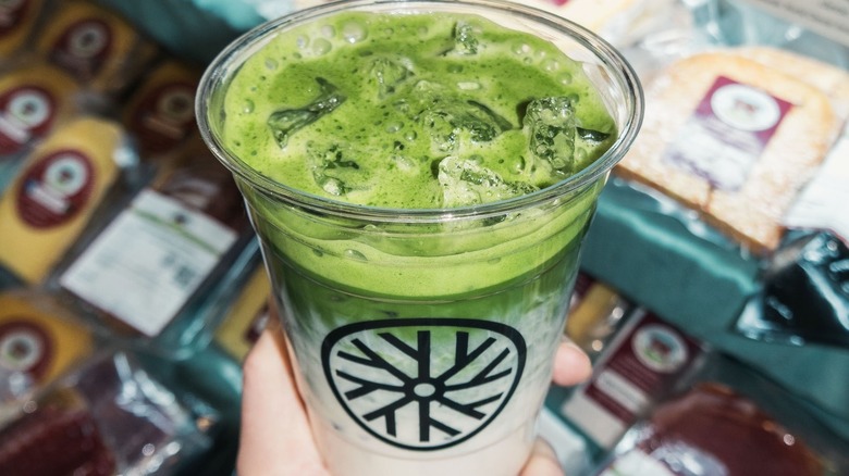 holding an iced matcha