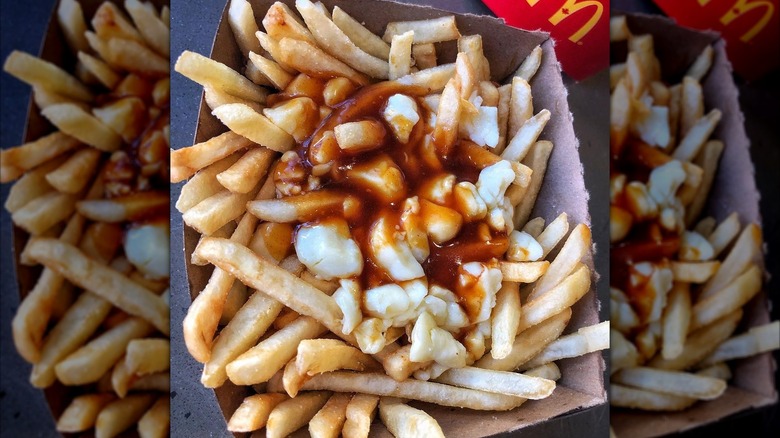 McDonald's Poutine in a brown cardboard container with a red McDonald's container in the background