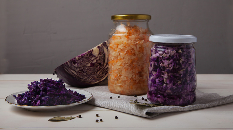 Two jars of sauerkraut with metal lids
