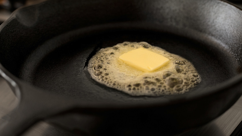 Close up of butter melting in a cast-iron skillet