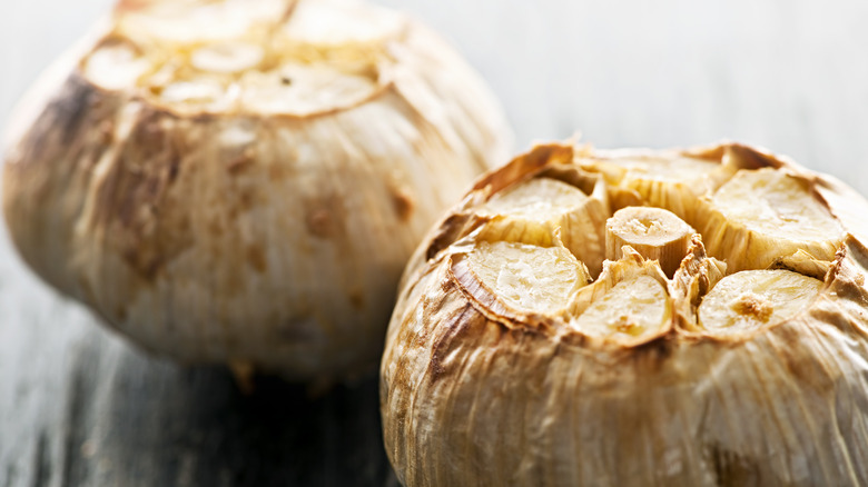 Close-up of roasted garlic heads with the tops cut off