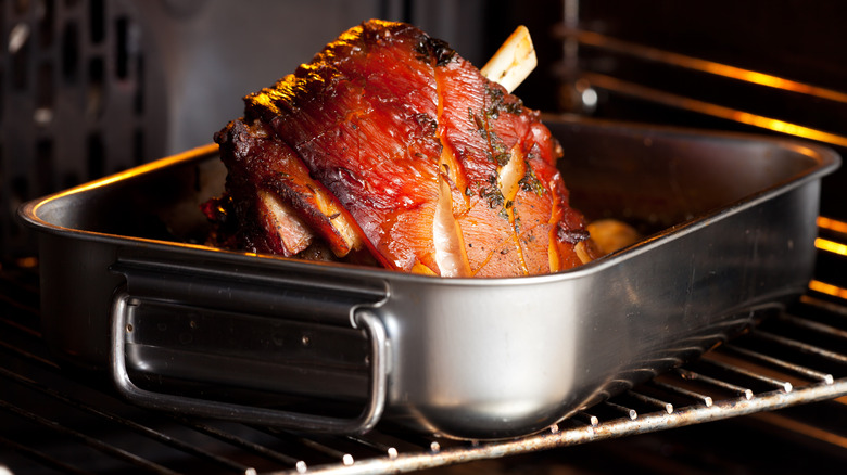 Glazed ham roast cooking in oven