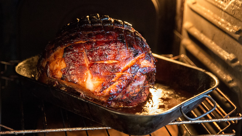 Well-cooked ham on tray inside oven