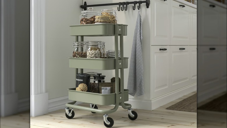 A RÅSKOG﻿ cart holding pantry essentials in kitchen