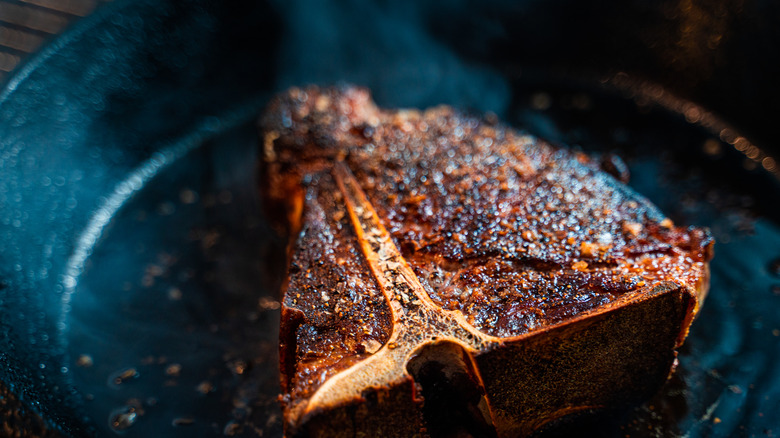 Steak searing in a cast-iron pan