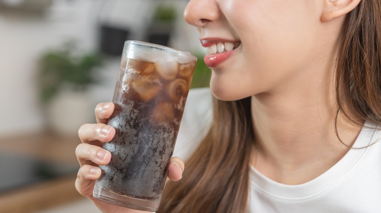 Woman sipping soda