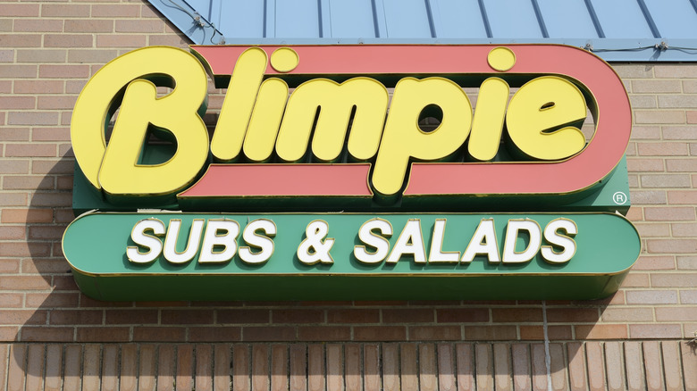 Store sign for Blimpie affixed to a brick facade