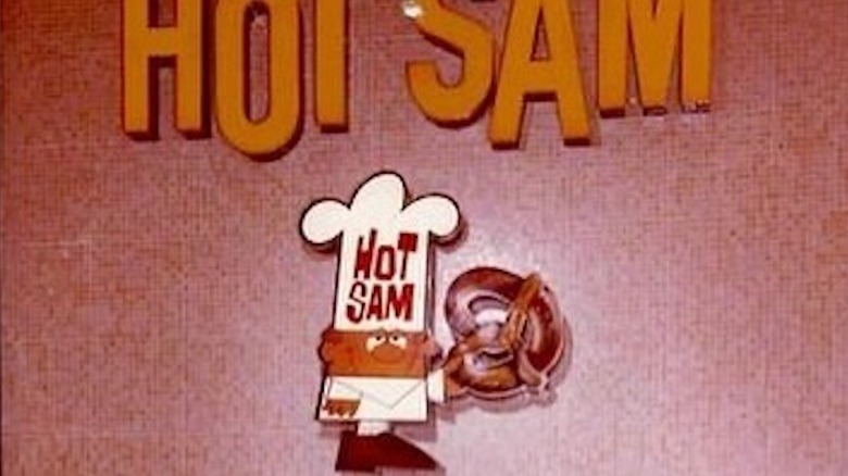 Hot Sam sign and mascot above the counter
