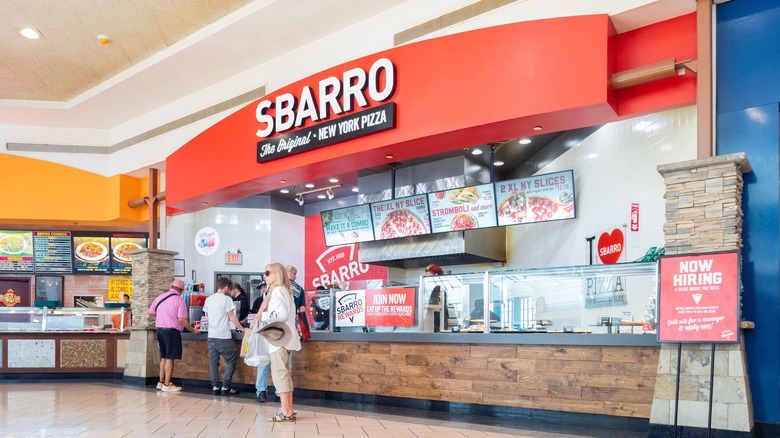 Customers lined up at a food court Sbarro