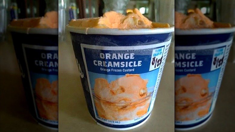 A pint of Culver's Orange Creamsicle custard sits on a cabinet.