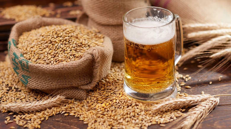 Beer in glass mug with bag of grain