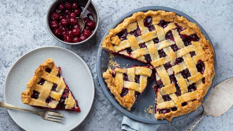Linzer torte with slice on white plate