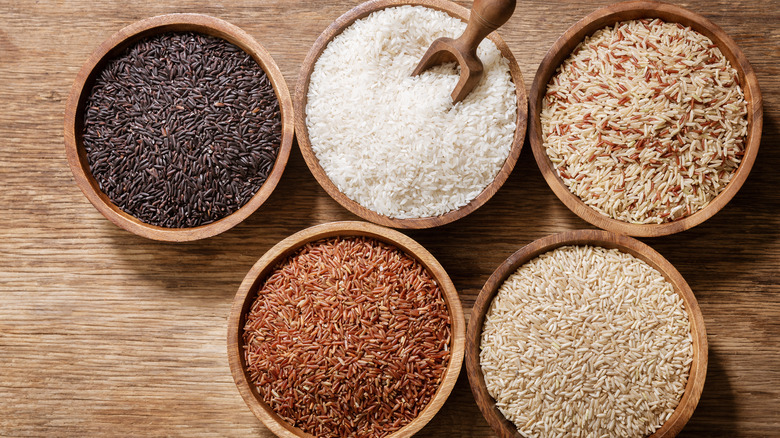 Various types of rice in wooden bowls