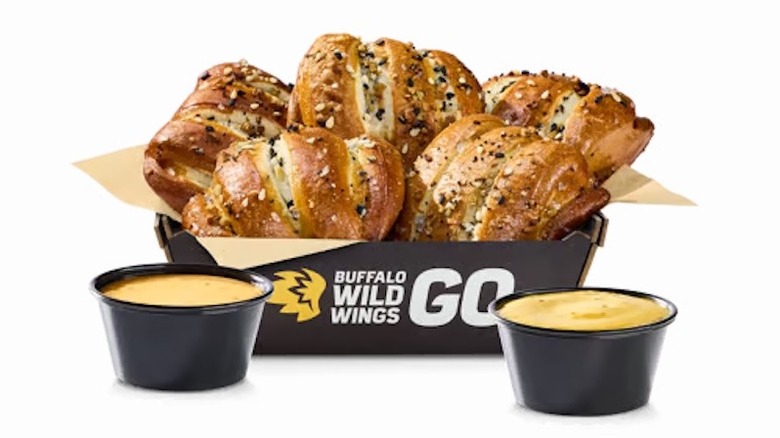 Basket of Everything Pretzel Knots with cups of New Belgium Fat Tire Beer Cheese and honey mustard from Buffalo Wild Wings.