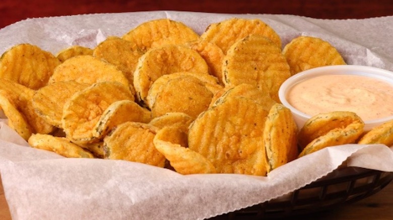Basket of Fried Pickles with cajun sauce from Texas Roadhouse.