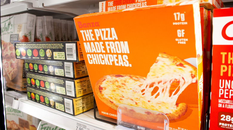 A Banza frozen pizza is displayed in a grocery store cold case