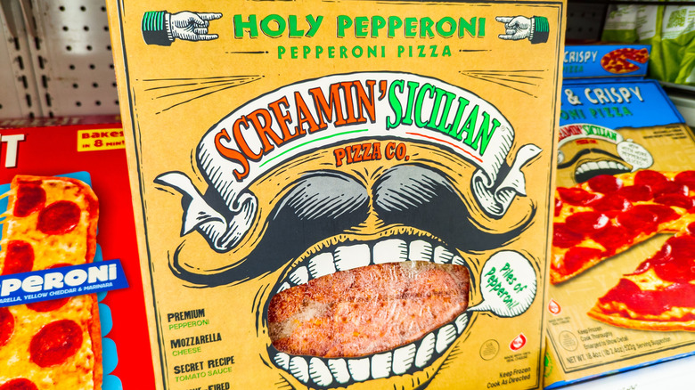 A Screamin' Sicilian Pizza is displayed in a grocery store cold case