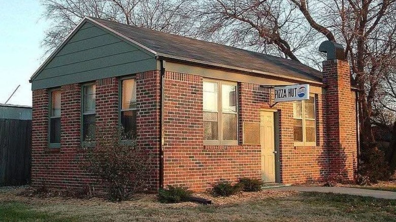 The small brick building housing the first Pizza Hut location
