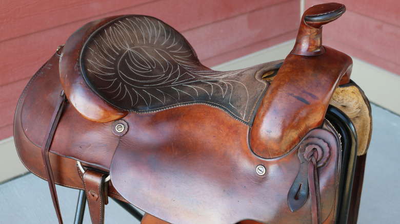 a western saddle on a saddle stand
