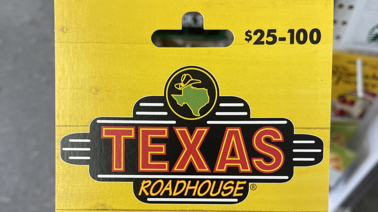 a Texas Roadhouse gift card in a yellow cardboard sleeve