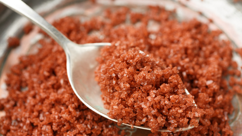 close up of Hawaiian red salt with a metal spoon