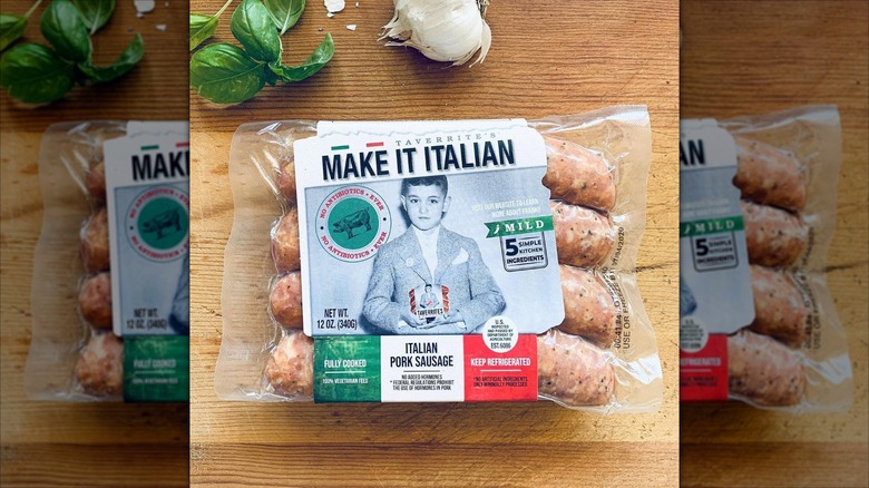 A package of Taverrites Make It Italian mild Italian pork sausages is on a wooden table.