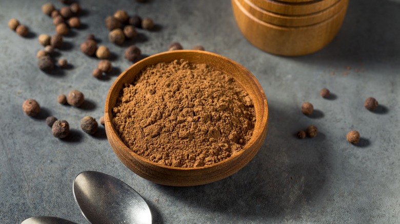 Ground allspice in a wooden bowl
