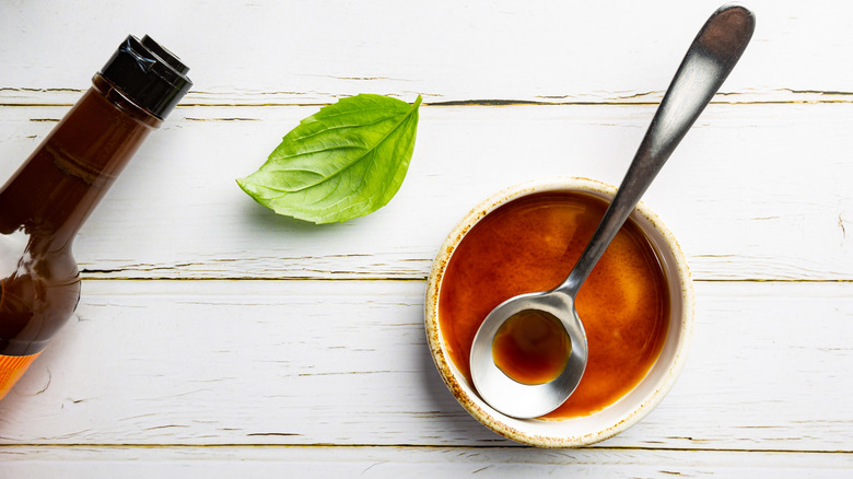 Worcestershire sauce in a bowl with a metal spoon